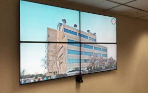 Photo of a four-screen digital display on the wall of one of the workspaces at Tower Place